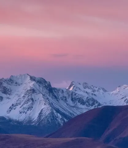 mountains with a blue haze over a red sky